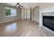 Bright and airy living room boasting hardwood floors, fireplace, and large windows at 2258 Whistler Dr, Longmont, CO 80504