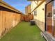 Small backyard with grass, wooden fence, and AC unit at 750 Tabor St # 18, Lakewood, CO 80401