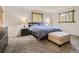 Cozy bedroom featuring a comfortable queen-size bed, plush carpet, and natural light from rustic wood-framed windows at 12348 Quartz Spur, Conifer, CO 80433