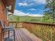 Inviting wood deck with outdoor seating and picturesque mountain views on a sunny day at 12348 Quartz Spur, Conifer, CO 80433