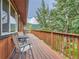 Relaxing wooden deck with seating perfect for enjoying the serene, wooded surroundings at 12348 Quartz Spur, Conifer, CO 80433