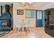 Charming dining area with a wood-burning fireplace, dining set, and natural light at 12348 Quartz Spur, Conifer, CO 80433