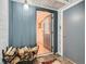 Welcoming entryway with a woodpile, tile flooring, and a view of an interior dining area, blending utility with comfort at 12348 Quartz Spur, Conifer, CO 80433