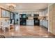 Bright kitchen with wood floors, white cabinets, modern appliances, and eat-in dining area at 12348 Quartz Spur, Conifer, CO 80433