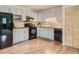 Bright kitchen featuring white cabinets, modern appliances, and butcher block countertops at 12348 Quartz Spur, Conifer, CO 80433