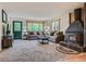 Comfortable living room with plush seating, wood-burning fireplace, and natural light at 12348 Quartz Spur, Conifer, CO 80433