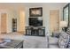 Cozy living room with neutral tones, decorative shelving, and entertainment center at 12348 Quartz Spur, Conifer, CO 80433
