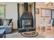 Inviting living room with a striking black fireplace, comfortable seating, and hardwood floors that add warmth to the space at 12348 Quartz Spur, Conifer, CO 80433