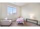 Bright bedroom with large window and comfortable seating at 12943 N Lafayette St # H, Thornton, CO 80241