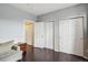 Bedroom featuring dark floors, neutral wall colors, and multiple closet spaces at 14221 E 1St Dr # 208, Aurora, CO 80011