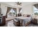 Sunlit bedroom with large windows, dark wood floors, and classic furniture at 14221 E 1St Dr # 208, Aurora, CO 80011