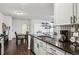 Bright kitchen with a sink overlooking a dining table and living room area with a couch at 14221 E 1St Dr # 208, Aurora, CO 80011