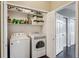 Well-organized laundry room with washer, dryer, and shelving for storage at 14221 E 1St Dr # 208, Aurora, CO 80011