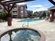 Community pool and hot tub surrounded by comfortable lounging space at 14221 E 1St Dr # 208, Aurora, CO 80011