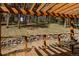 Outdoor living space featuring a wooden deck with pergola and rock retaining wall at 8626 Junco Trl, Evergreen, CO 80439