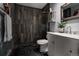 Modern bathroom featuring a sleek vanity, open shower, and dark stone tile at 8626 Junco Trl, Evergreen, CO 80439
