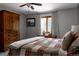 Comfortable bedroom boasts a large wardrobe, a dresser, and a window with light-filtering curtains at 8626 Junco Trl, Evergreen, CO 80439