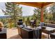 Spacious deck with outdoor seating, grill, and mountain views at 8626 Junco Trl, Evergreen, CO 80439