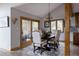 Elegant dining room with wood floors, antler chandelier, and sliding glass doors to the outdoor area at 8626 Junco Trl, Evergreen, CO 80439