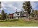 Gray two-story home with large windows and multiple decks at 8626 Junco Trl, Evergreen, CO 80439