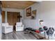 Home gym featuring workout equipment and two white armchairs at 8626 Junco Trl, Evergreen, CO 80439