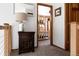 Hallway view into a bedroom, featuring decor, wood trim, and natural light at 8626 Junco Trl, Evergreen, CO 80439