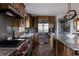 High-end kitchen featuring a large island, stainless steel appliances, and wood cabinets with ample storage at 8626 Junco Trl, Evergreen, CO 80439