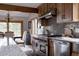 Gourmet kitchen with custom wood cabinets, stainless steel appliances, granite countertops, and eat-in dining at 8626 Junco Trl, Evergreen, CO 80439