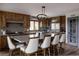 Spacious kitchen boasts custom wood cabinets, granite countertops, high-end appliances, and a large island with seating at 8626 Junco Trl, Evergreen, CO 80439