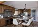 Open kitchen with stainless steel appliances, granite countertops, a large island, and wood cabinets at 8626 Junco Trl, Evergreen, CO 80439