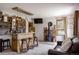 Open living space with a bar, fireplace, comfortable seating, and natural light at 8626 Junco Trl, Evergreen, CO 80439