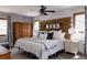 Bright main bedroom with a stylish wood headboard, plush pillows, and an adjacent wardrobe at 8626 Junco Trl, Evergreen, CO 80439