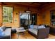 Relaxing porch with stylish furniture and wooded mountain views at 8626 Junco Trl, Evergreen, CO 80439
