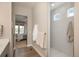 Open doorway to bedroom adjacent to tiled shower at 8548 S Quatar St, Aurora, CO 80016