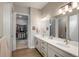 Bright bathroom with double vanity, sleek countertops, and modern fixtures provides a luxurious experience at 8548 S Quatar St, Aurora, CO 80016