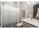 This bathroom is well-lit, and features a shower/tub, toilet, and single sink at 8548 S Quatar St, Aurora, CO 80016