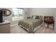 Bright bedroom features neutral tones, a large window, and comfortable carpet at 8548 S Quatar St, Aurora, CO 80016