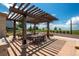 Outdoor shaded community space with tables and chairs for gatherings and relaxation at 8548 S Quatar St, Aurora, CO 80016