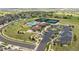 Aerial view of the community center featuring a pool, tennis courts, parking lot, and landscaping at 8548 S Quatar St, Aurora, CO 80016