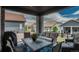 Relaxing covered patio with comfortable seating, a dining table, and views of the fenced backyard at 8548 S Quatar St, Aurora, CO 80016