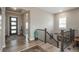 Spacious foyer featuring wood floors, an elegant staircase, and natural light at 8548 S Quatar St, Aurora, CO 80016