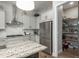 Modern kitchen featuring stainless steel appliances, granite countertops, and a convenient walk-in pantry at 8548 S Quatar St, Aurora, CO 80016
