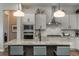 Modern kitchen features stainless steel appliances, a large island, and sleek white cabinetry at 8548 S Quatar St, Aurora, CO 80016