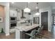 Bright kitchen with stainless steel appliances, granite countertops, and a large kitchen island with seating at 8548 S Quatar St, Aurora, CO 80016