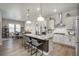 Bright kitchen featuring a large island with bar seating, stainless steel appliances, and pendant lighting at 8548 S Quatar St, Aurora, CO 80016