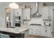 Updated kitchen with a large island, stainless steel appliances, and sleek white cabinets at 8548 S Quatar St, Aurora, CO 80016