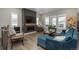 Cozy living room boasts a modern fireplace, custom mantel, and large windows at 8548 S Quatar St, Aurora, CO 80016
