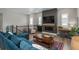 Comfortable living room offering a fireplace, wood-style flooring, and natural light at 8548 S Quatar St, Aurora, CO 80016