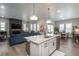 Bright, open-concept living space with hardwood floors, fireplace, and a modern kitchen with a large island at 8548 S Quatar St, Aurora, CO 80016