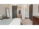 Bedroom featuring modern barn door and a glimpse into the luxurious walk-in closet at 8548 S Quatar St, Aurora, CO 80016